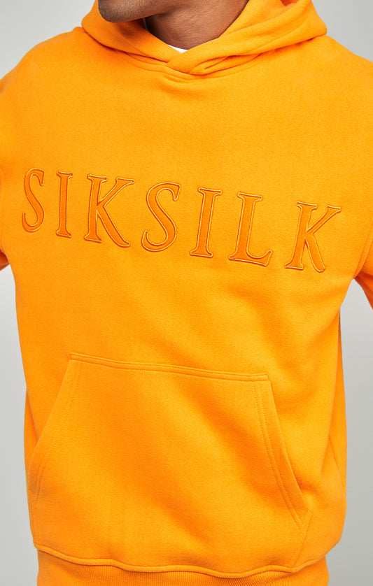 Orangefarbener Overhead Kapuzenpullover mit Logoapplikation in entspannter Passform